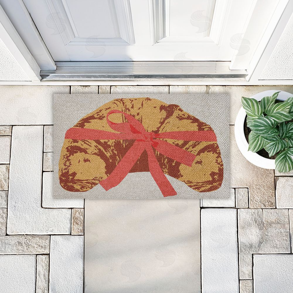 Stupell Studio | Bakery Croissant with Ribbon Faux Sisal Door Mat